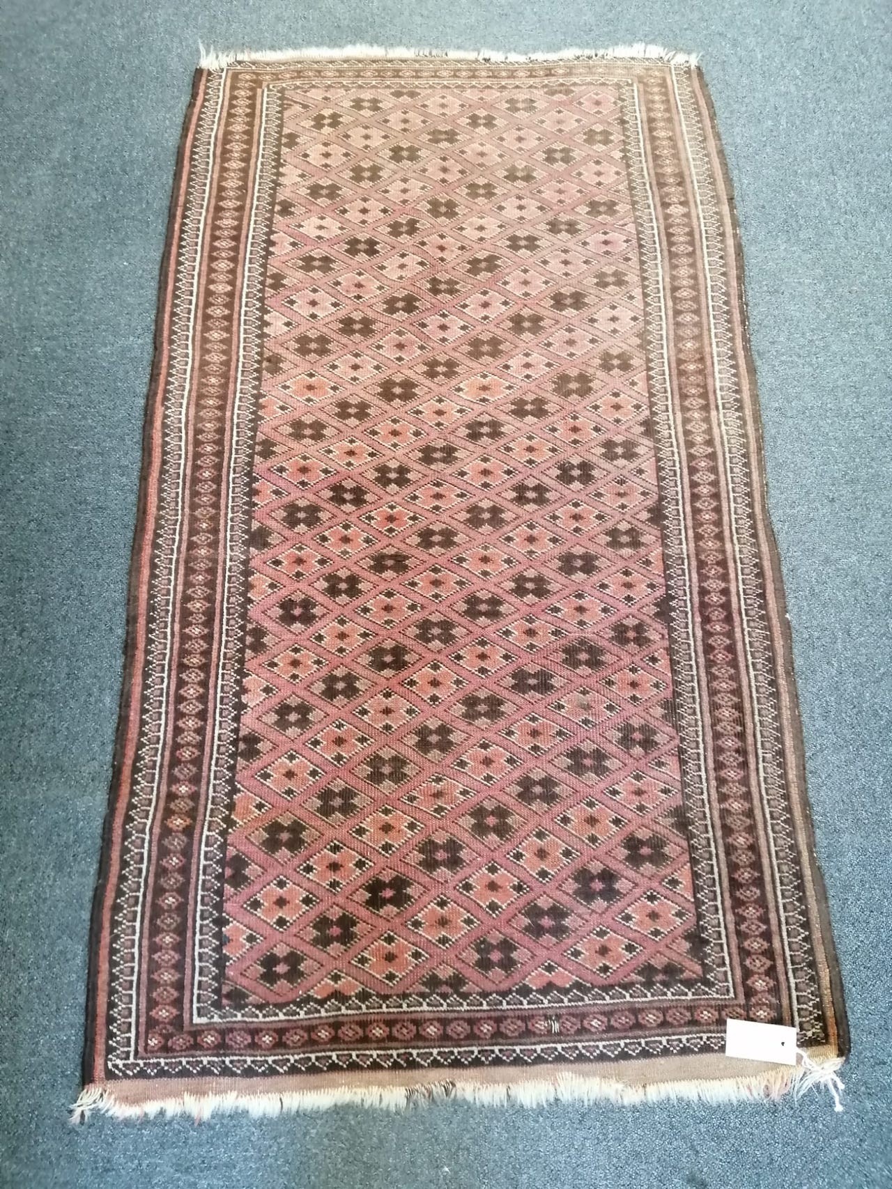 A Belouch red ground rug, 142 x 80cm